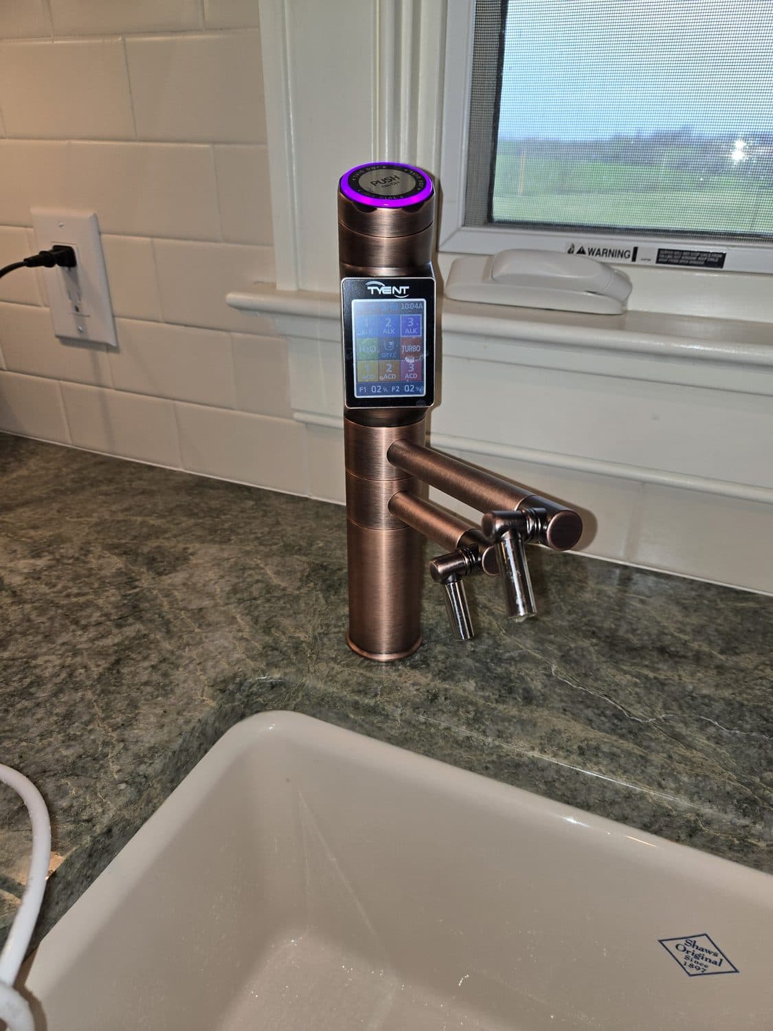 D'Pure Tyent alkaline ionizer faucet installed at a kitchen sink